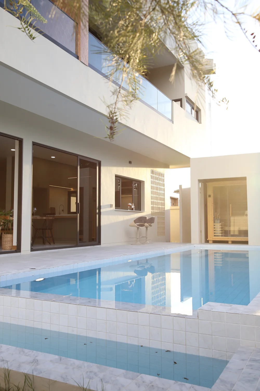 Warm light across the Villa Alive pool courtyard