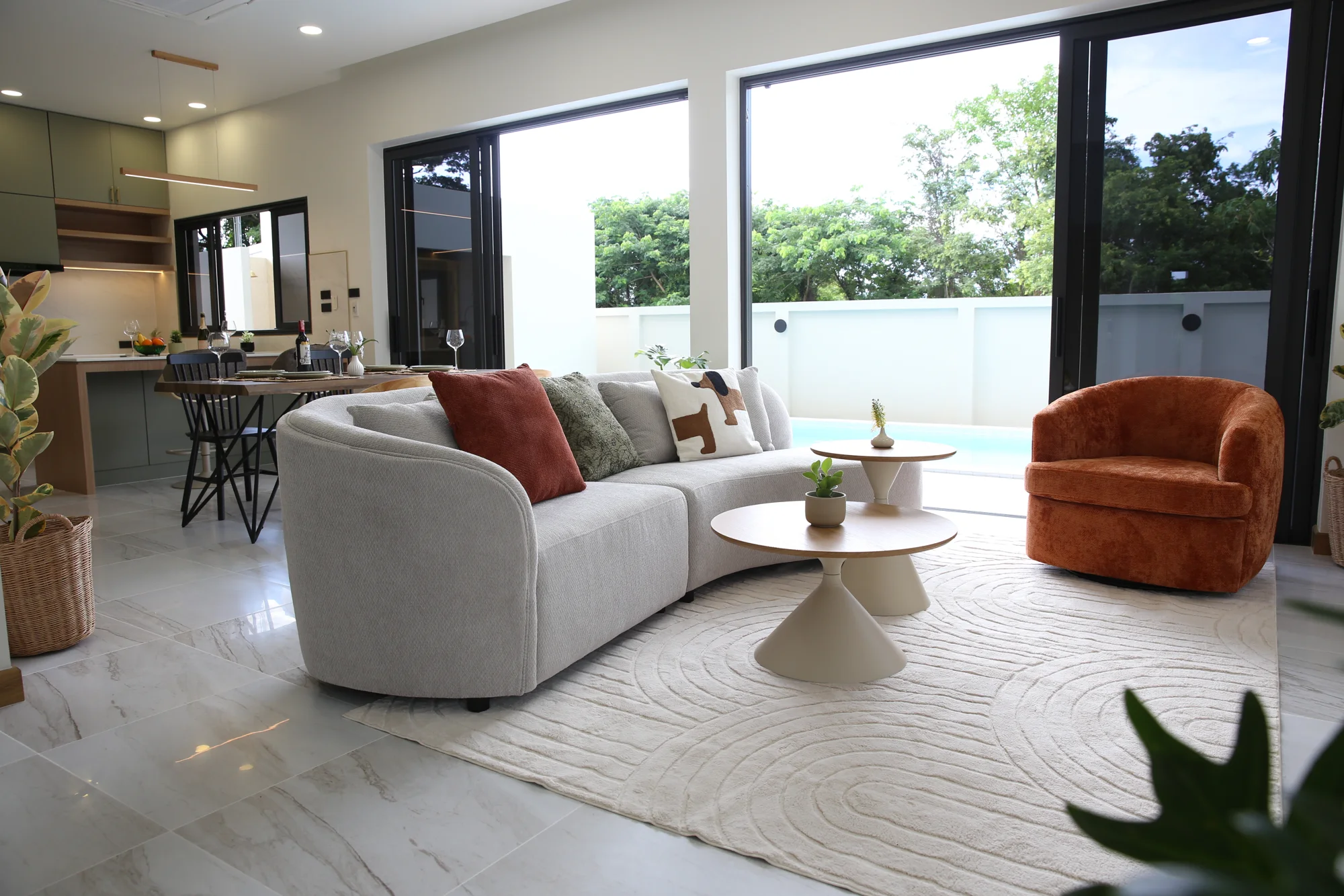 Open living and dining areas connecting to the Villa Alive pool